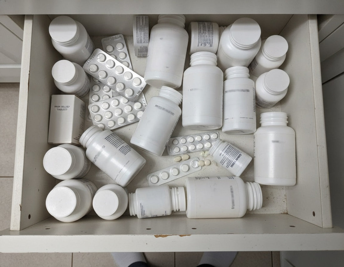 A cluttered drawer full of half-used pill bottles and blister packs