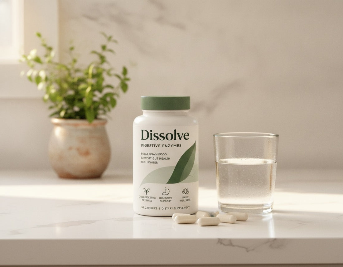 A bottle of Dissolve on a white kitchen counter with capsules and a glass of water